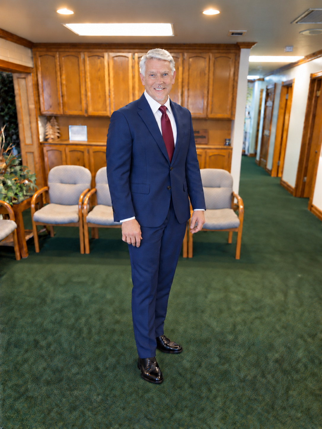Dr. Curtis Loeffler in a navy-blue suit and burgundy tie at Hemet Chiropractic